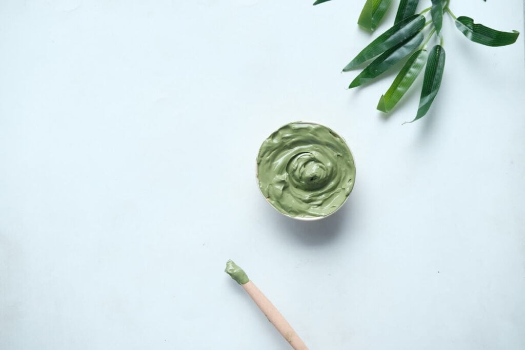 a bowl of mask next to a brush